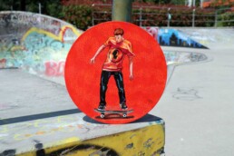 Skater painting on vinyl record at skate park By Claudio Bindella